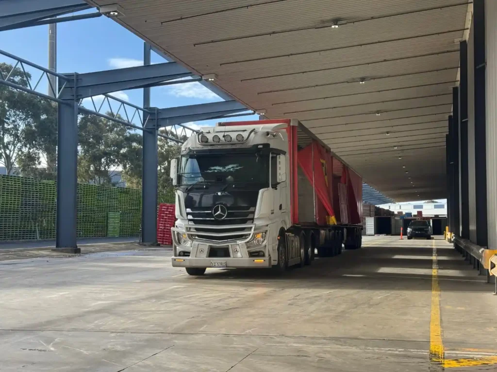 Technician checking DEF tank levels on diesel fleet vehicle before morning dispatch